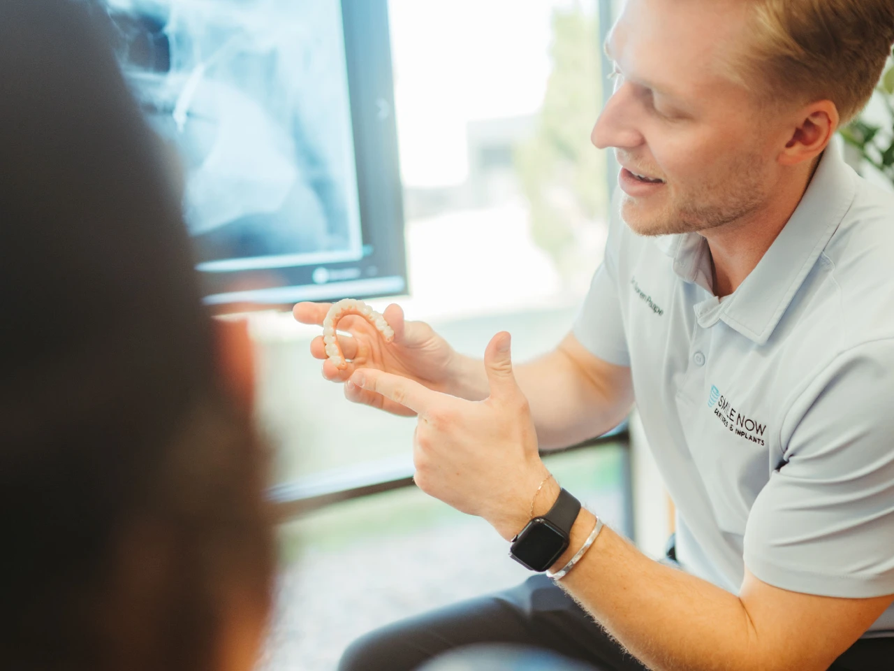 Patient discussing all on 4 dental implants cost with Dr. Soren Paape for full mouth restoration